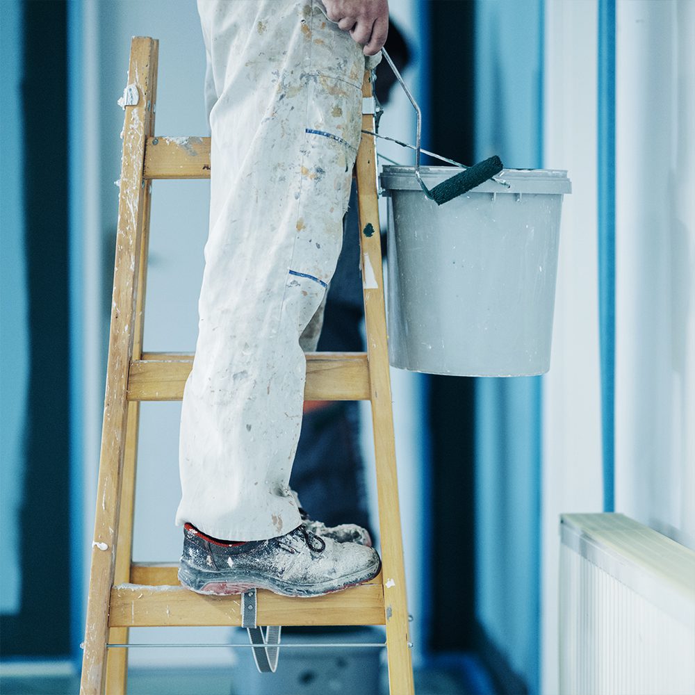 painter on ladder doing project